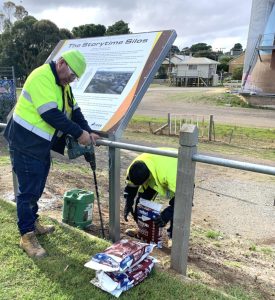 Storyboard signage being installed at the Eudunda Silo Art